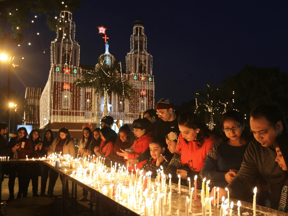 a group of people lighting candles at a church